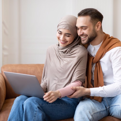 Man and woman looking at their laptop